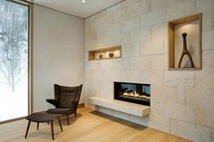 a living room with a chair and fireplace in it