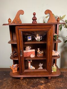 a wooden shelf with figurines on top of it