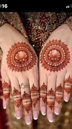 two hands with henna designs on them