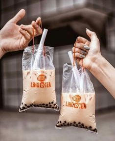 two people holding bags with liquid in them