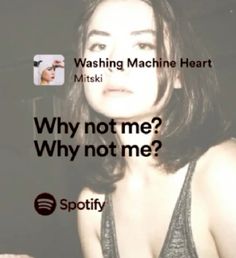 a woman is looking at the camera with an ad in front of her that reads, washing machine heart miski why not me? why not me?