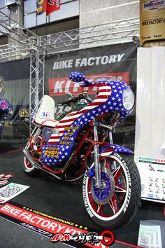 a red, white and blue motorcycle is on display