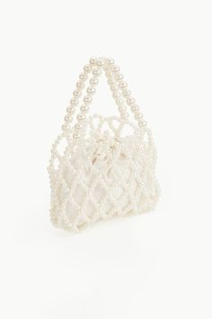 This eye-catching purse with ravishing beauty is the perfect to-go bag to any cocktail parties. It has its unique sparkle and will shine more brightly with you carrying it. Features: Durable inner bag Drawstring closure design Detachable pearl chain attached 9 inch / 20 cm x 7.1 inch / 18 cm ( L x H ) Pearl White Beaded Shoulder Bag For Party, Glamorous Pearl Clutch With Pearl Handle, White Pearl Evening Bag For Party, White Evening Bag With Pearl Chain, Pearl Clutch For Party, Pearl White Clutch For Parties, Elegant Evening Bags With Pearl Chain, Pearl Embellished Evening Bag For Party, Party Embellished Pearl Evening Bag