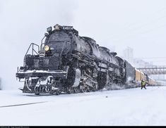 a train traveling down tracks covered in snow