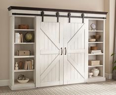 an open bookcase with sliding doors in a living room