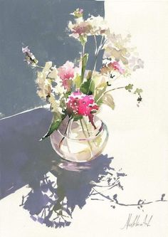 a glass vase filled with lots of flowers on top of a table next to a wall