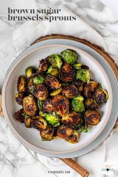 brussel sprouts in a white bowl on top of a marble table