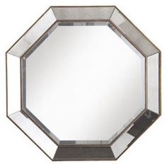 a mirror that is sitting on top of a table with a black base and silver trim