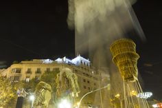 an artistic view of a city at night with buildings in the background and lights on