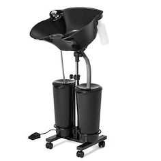 a black chair with two buckets attached to the back and wheels on each side