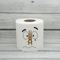 a toilet paper roll with a face drawn on it