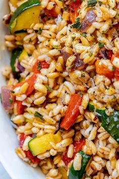 a white bowl filled with rice and vegetables