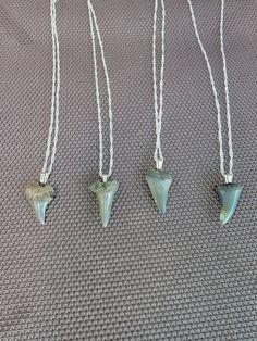 Hand picked Prehistoric Mako sharks teeth made onto 18 inch silver necklaces! Teeth sizes range from 1 inch to 7/8 of an inch! Est. Age 16 million years old! Shark Tooth Necklace Mens, Animal Tooth Necklace, Megladon Tooth Necklace, Men’s Shark Tooth Necklace, Tiger Tooth, Arrowheads Design, Mako Shark, Shark Tooth Necklace, Tooth Necklace