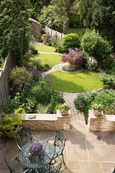 an outdoor patio with tables and chairs in the middle of it, surrounded by greenery