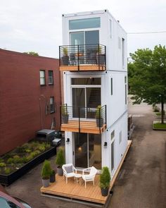 an apartment building with two balconies on the second floor