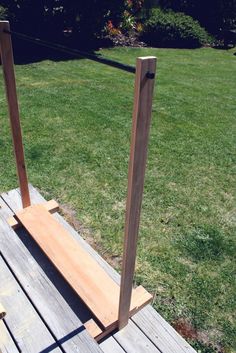 a wooden bench sitting on top of a grass covered field