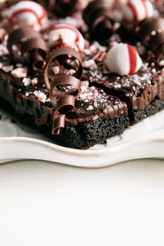 a close up of a cake on a plate with candy canes and candies