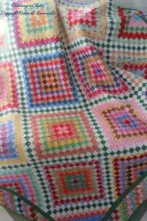 a crocheted blanket is sitting on the floor