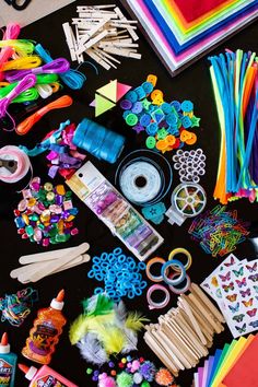 many craft supplies are laid out on the table