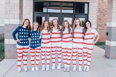 a group of women standing next to each other wearing american flag pajamas and matching sweaters