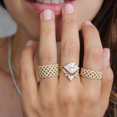 a close up of a person wearing two rings on their fingers and the other hand