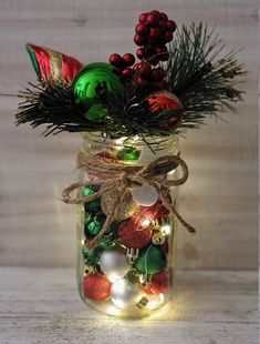 a mason jar filled with ornaments and lights