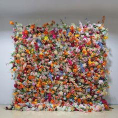 an art installation made out of flowers on the wall