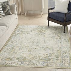 a living room area with couches, chairs and rugs