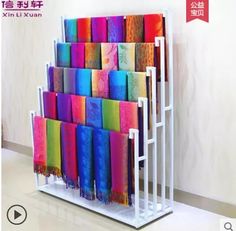 there is a rack with many different colored papers on it