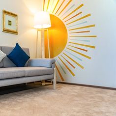 a living room with a couch, lamp and painting on the wall