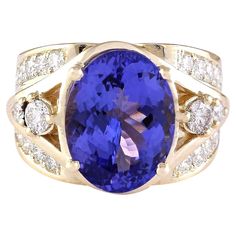 Discover sheer elegance and sophistication with our breathtaking Natural Tanzanite and Diamond Ring, meticulously crafted in luxurious 14K Yellow Gold. Each detail speaks to the utmost quality and beauty, from the distinguished 14K stamp affirming its authenticity to the substantial total ring weight of 10.2 grams, ensuring both substance and style. At the heart of this enchanting piece lies a magnificent Tanzanite gemstone, boasting a generous weight of 7.24 carats and measuring 14.00x10.00 mm. Elegant Gold Tanzanite Diamond Ring, Luxury Tanzanite Diamond Ring For Formal Occasions, Jewelry 2022, Tanzanite And Diamond Ring, Yellow Gold Cocktail Ring, Real Diamond Necklace, 1st Dibs, Tanzanite Diamond Ring, Yellow Gold Diamond Ring