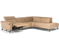 a beige leather sectional sofa with an ottoman