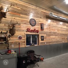 the inside of a building with deer heads on the wall and other decorations hanging from the ceiling