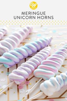 unicorn lollipops are lined up on a table