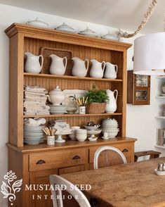 a wooden hutch filled with lots of dishes