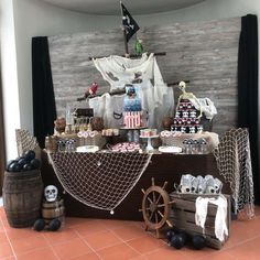 a pirate themed dessert table with cupcakes and treats