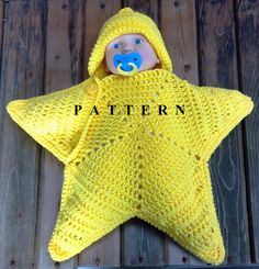 a crocheted yellow star with a blue teddy bear in it