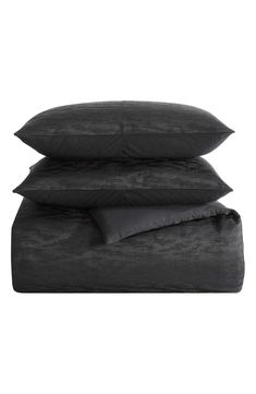 three black pillows stacked on top of each other