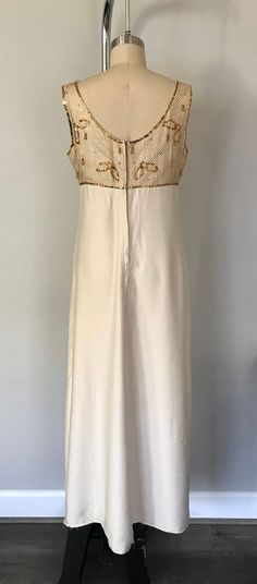 This is a gorgeous1950s vintage all hand made wedding/reception dress Gold and silver sparkles rhinestones beaded over gold mesh on front and back on upper. Kept in incredible condition and very lovely. empire waist and hook and zipper closure on back hem line is undone but can be hemmed to personal length of liking. Size:small to medium measurements shoulder to shoulder: 14 in. just below bust where empire waist line is: 31.5 in. bust: 37 inches waist: 32.5 in. total length: 53 in. material: si Cream Long Dress, Waist Wedding Dress, Empire Waist Wedding Dress, Wedding Dress Vintage, Wedding Reception Dress, Dress Gold, Reception Dress, Rhinestone Bead, Wedding Dresses Vintage