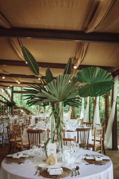 the table is set with white linens and place settings