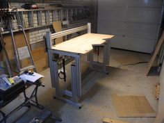 a workbench in a garage with tools on the table and shelves behind it