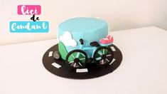 there is a cake that looks like a bike on the plate and has wheels attached to it