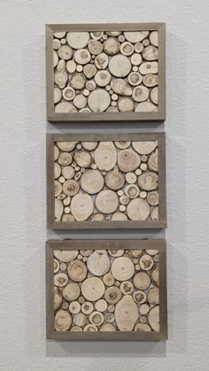 three pieces of wood are mounted on the wall in front of each other with circles