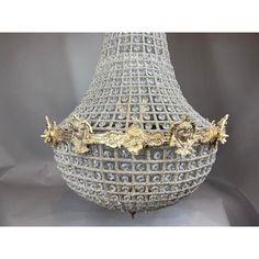 an ornate chandelier with gold trimmings and filigreens on the sides