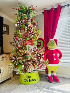 a christmas tree decorated with candy canes and lollipops in the shape of dr seuss