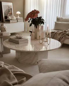 a marble table with candles and flowers on it