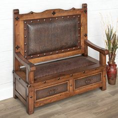 a wooden bench with two drawers underneath it and a potted plant next to it