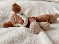 a stuffed animal laying on top of a bed