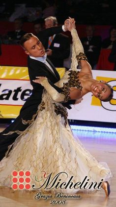 a man and woman dancing on top of a dance floor