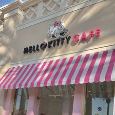 the hello kitty cafe has pink and white awnings on it's windows